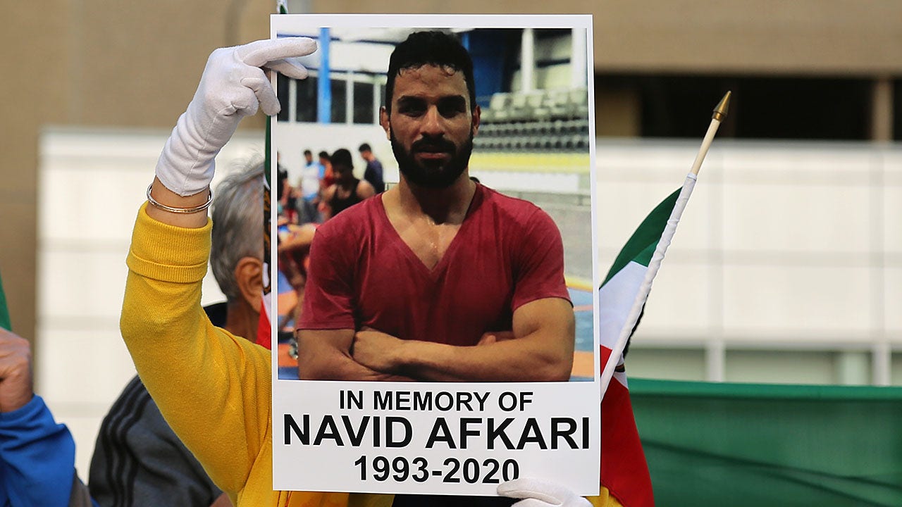 Iranian athletes at Tokyo Olympics remember murdered wrestler Navid Afkari