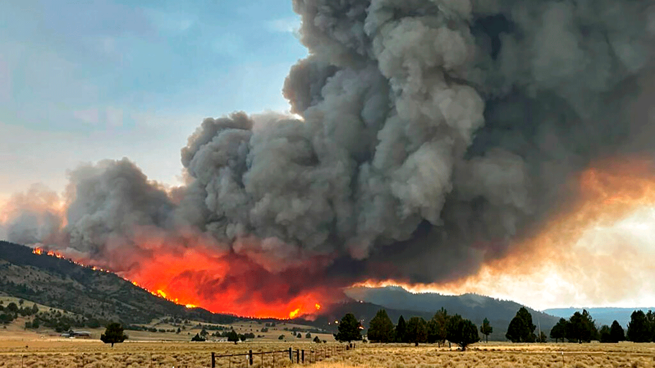 This Thursday, Aug. 12, 2021 photo provided by the U.S. Forest Service shows a wildfire burning from the Patton Meadows fire in southern Oregon. The fire west of Lakeview, Oregon near the California border started with a lightning strike Thursday and rapidly grew to 11 square miles in size amid tinder-dry drought conditions. The fire is near the Bootleg Fire, which until recently was the nation's largest wildfire.