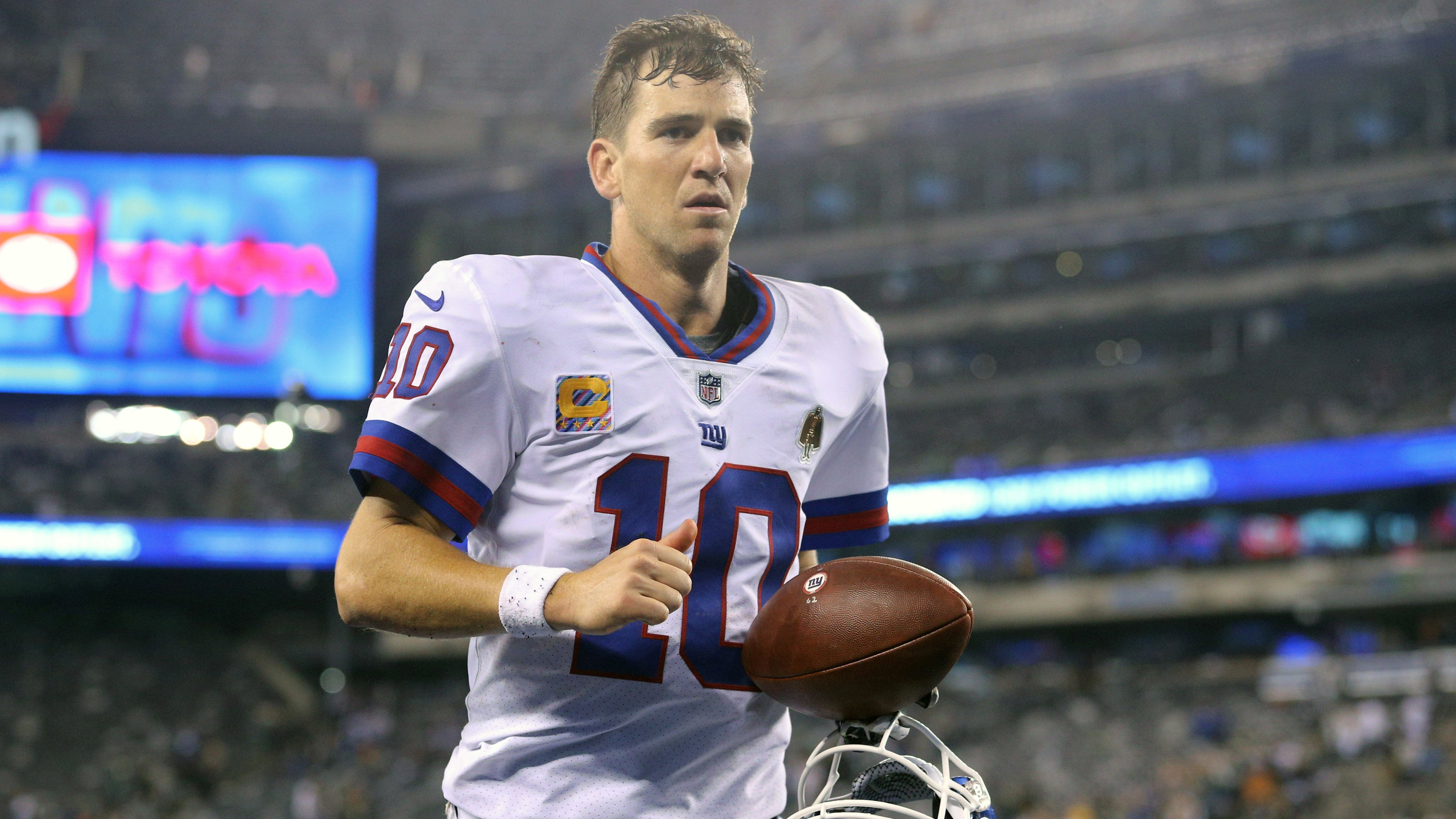 Eli takes picture with fan wearing 'Double Bird' jersey