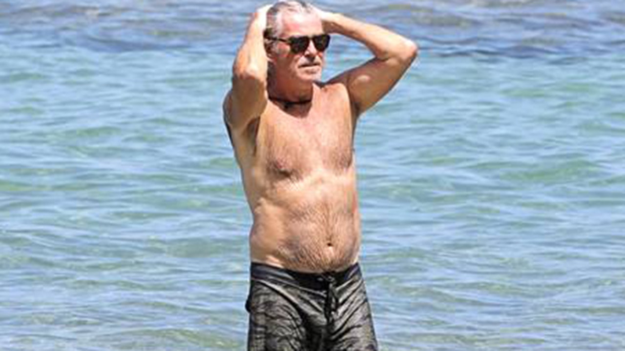 Shirtless Pierce Brosnan takes a dip in Hawaii