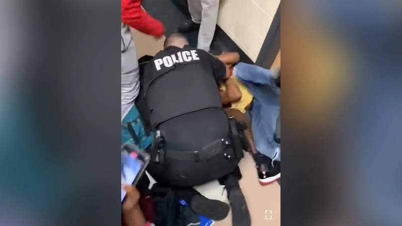 Virginia school resource officer uses body to shield student in high school brawl
