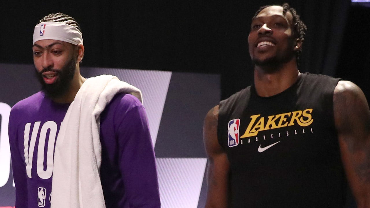 Los Angeles Lakers center Dwight Howard jokes with teammates