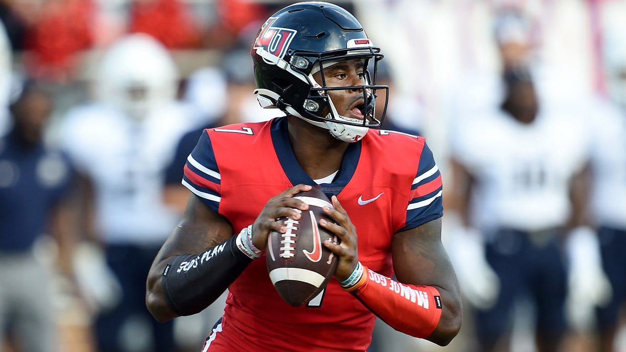 Liberty quarterback Malik Willis seen helping woman on street