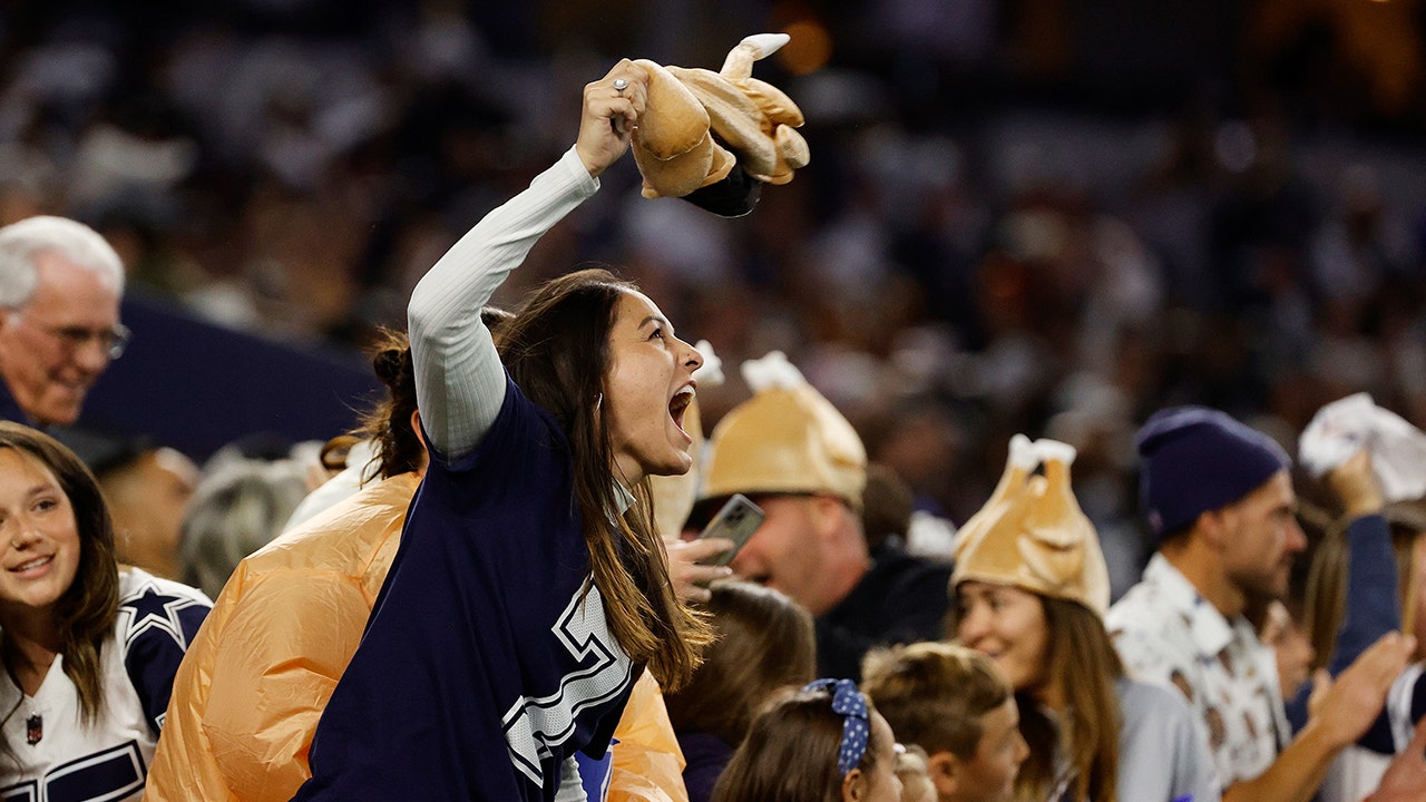 Fans wave team flags at an NFL game between the Oakland Raiders and the  Chicago Bears at Totten …