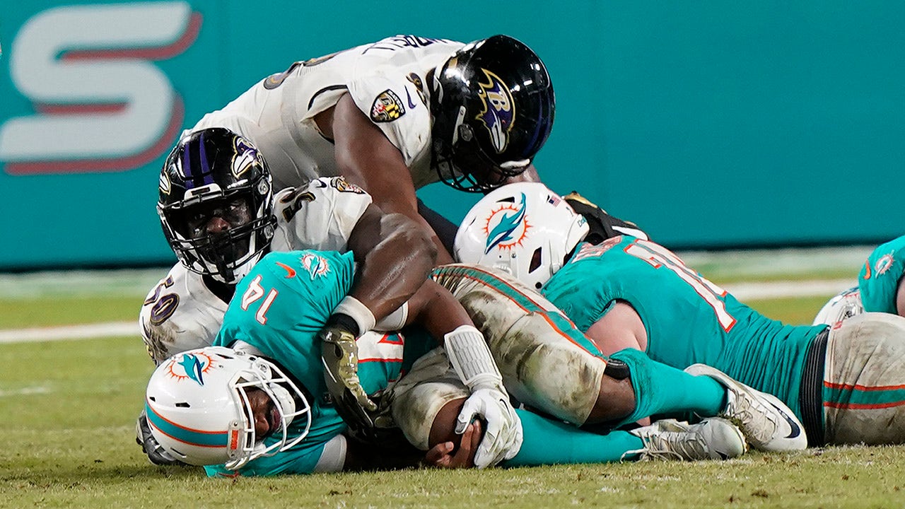 Miami Dolphins quarterback Jacoby Brissett (14) walks the