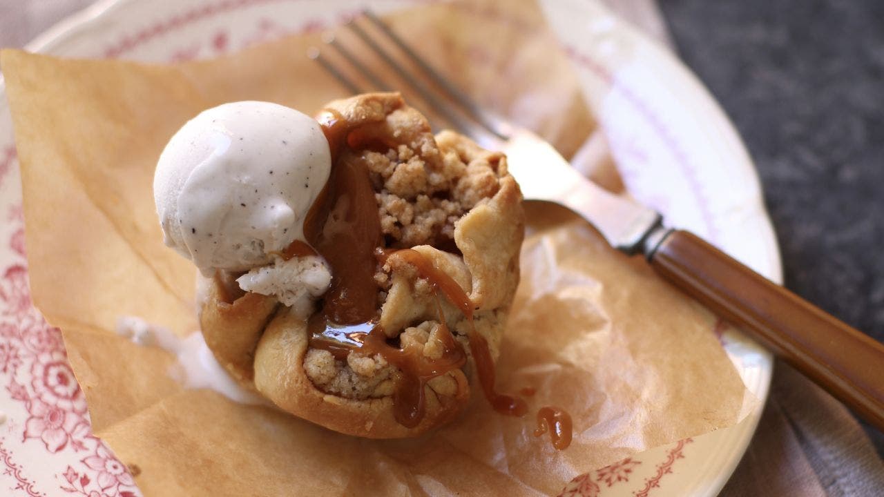 Mini caramel apple pies made in a muffin tin for Thanksgiving dessert
