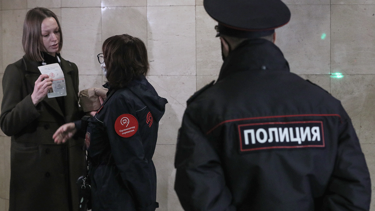 A police officer and a ticket collector enforce the face mask requirement at Trubnaya station of the Moscow Metro. Due to a surge in COVID-19 cases, the Moscow authorities has declared non-working days with pay from October 28 to November 7. Alexander Shcherbak/TASS (Photo by Alexander Shcherbak\TASS via Getty Images)