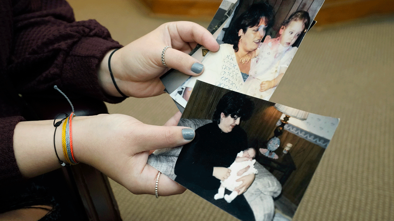 Lindsey Kirk shows childhood photographs of herself and her late mother, Kim Kirk Cox, Saturday, Nov. 13, 2021, in New Albany, Mississippi. 