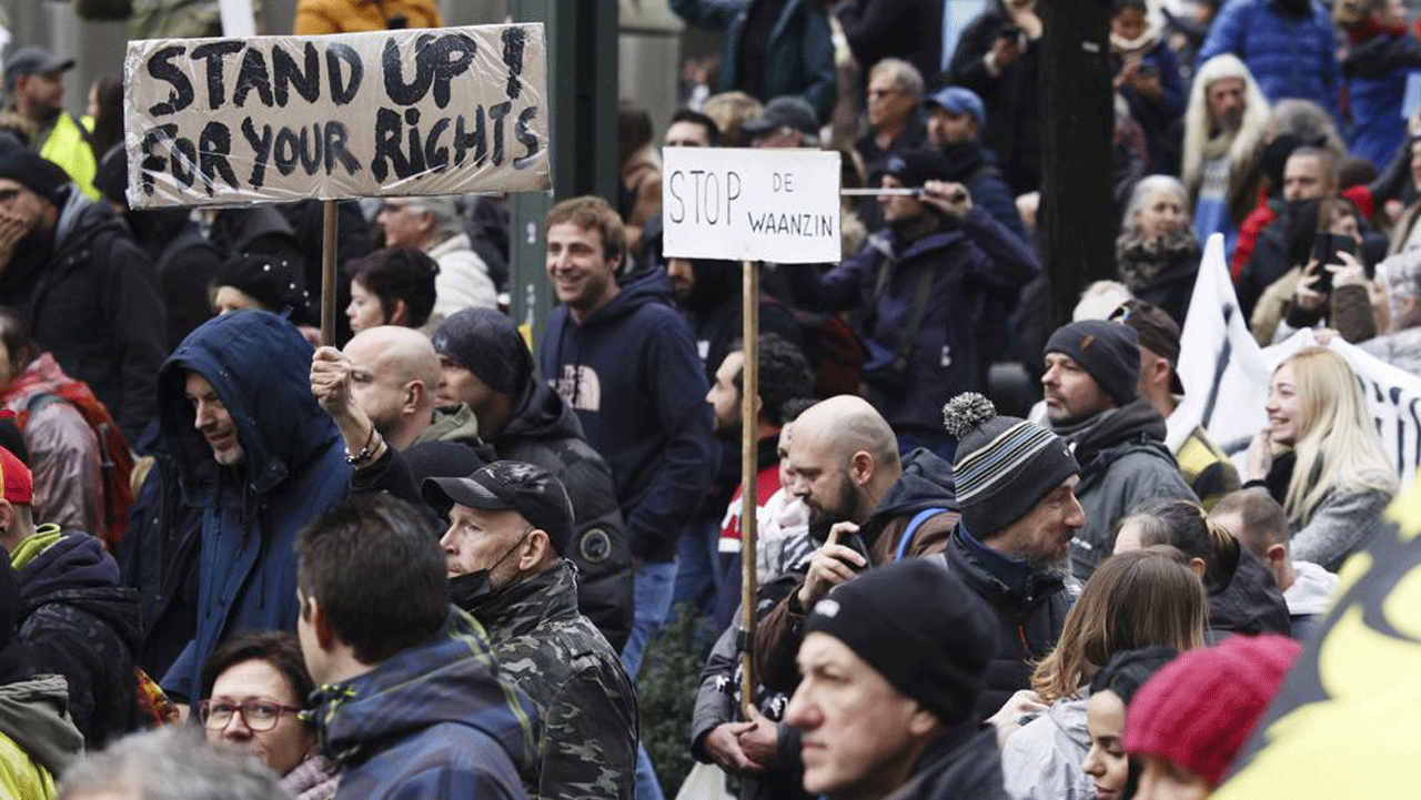 Protesters demonstrate against the government's efforts to counter the latest spike of the coronavirus in Brussels, Belgium, on Sunday, Nov. 21, 2021. 