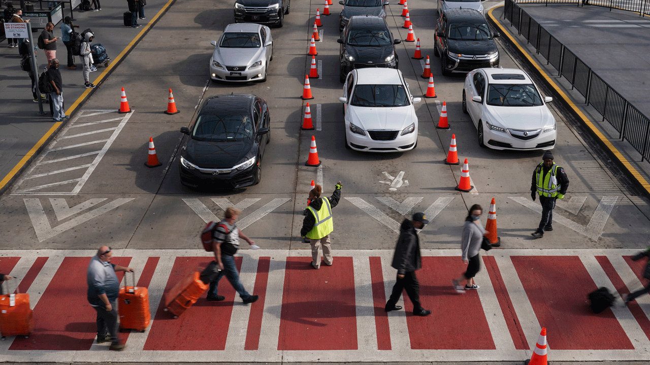 Travelers arrive and depart at the Hartsfield-Jackson Atlanta International Airport on Tuesday, Nov. 23, 2021, in Atlanta. 