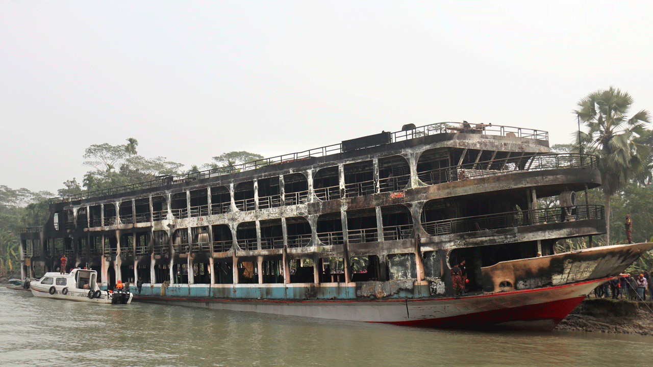 A burnt passenger ferry is seen anchored off the coast of Jhalokati district on the Sugandha River in Bangladesh, Dec. 24, 2021. 