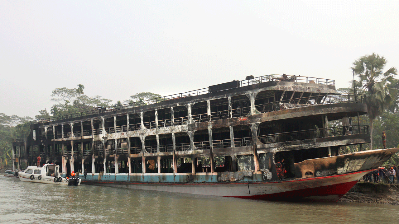 A burnt passenger ferry is seen anchored off the coast of Jhalokati district on the Sugandha River in Bangladesh, Friday, Dec. 24, 2021. Bangladesh fire services say at least 37 passengers have been killed and many others injured in a massive fire that swept through a ferry on the southern Sugandha River. The blaze broke out around 3 a.m. Friday on the ferry packed with 800 passengers. (AP Photo)