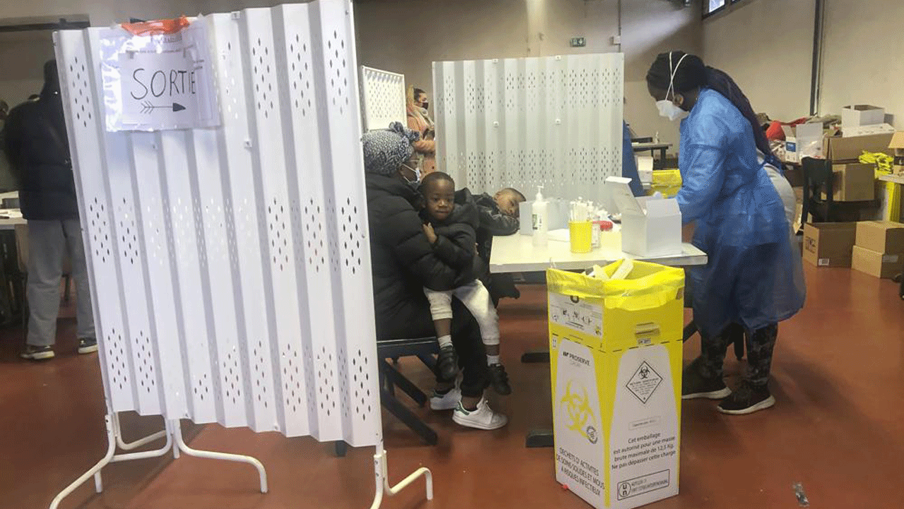 A medical staff prepares nasal swaps to test a woman with her children at a testing site on the Christmas Eve in La Celle-Saint-Cloud, west of Paris, Friday, Dec. 24, 2021. President Emmanuel Macron released a selfie-style TikTok video on Thursday calling on young people to get themselves tested before joining family members for the holidays. 