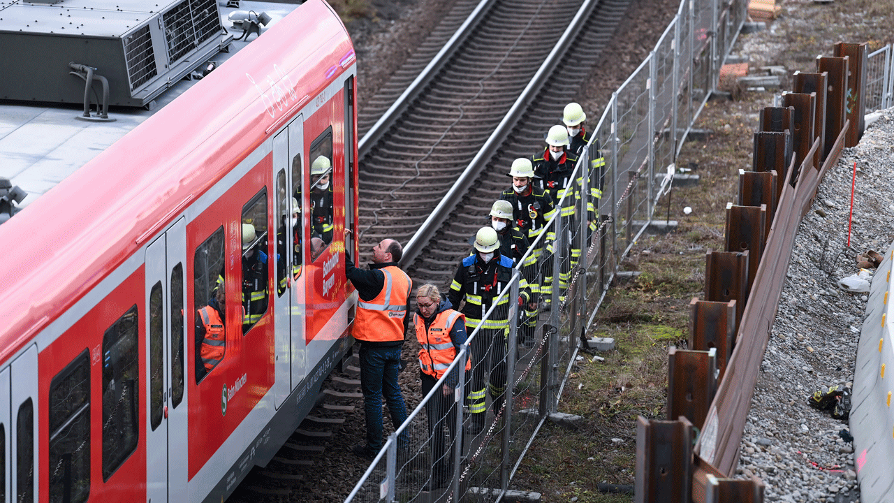 Firefighters and railway staff at a railway site in Munich, Germany, Wednesday, Dec. 1, 2021.