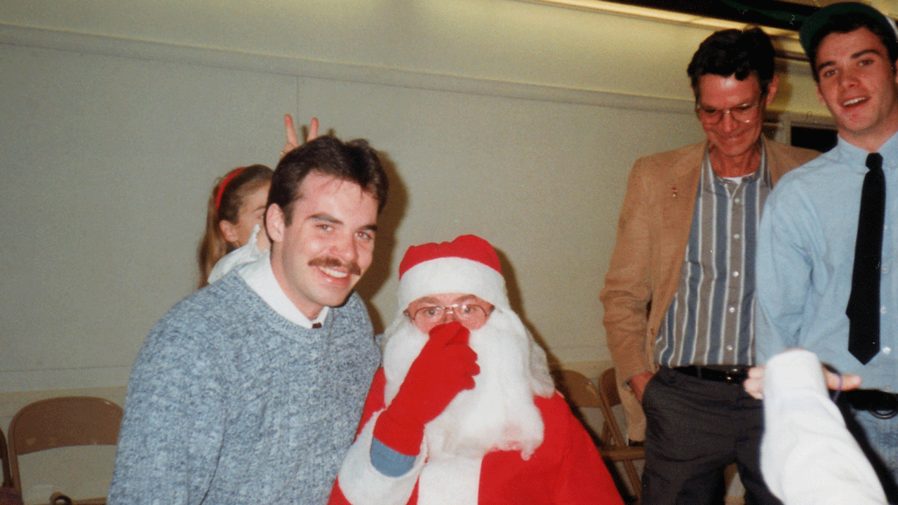 Eric Wasson sits on Santa's lap after receiving a box of "Santa's Book of Candy," a regift from his brother Ryan, during Christmastime 1992, in Chocorua, New Hampshire.