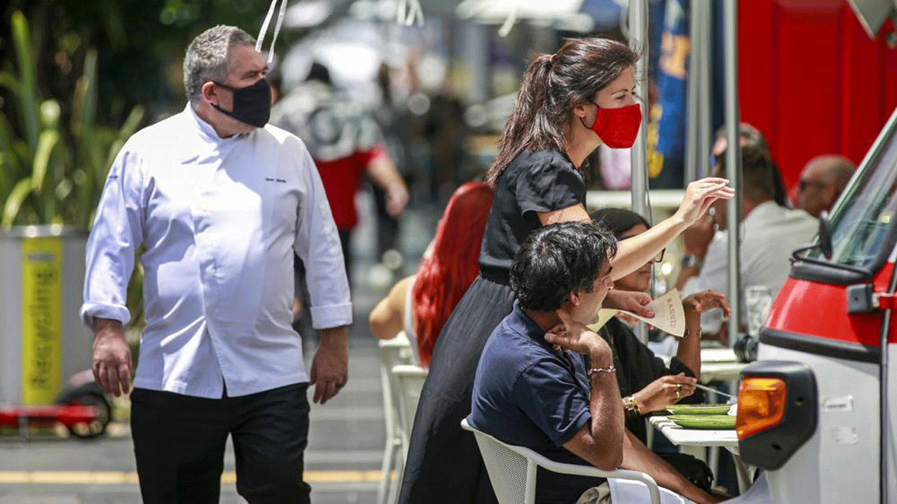 Customers enjoy meals and drinks at a restaurant in central Auckland, New Zealand, Friday, Dec. 3, 2021. Bars, restaurants and gyms reopened in Auckland on Friday as the last major parts of a lockdown that lasted more than 100 days ended. New Zealand has begun a new phase in its virus response in which there won't be lockdowns, but people will be required to show vaccine passes for many services. 