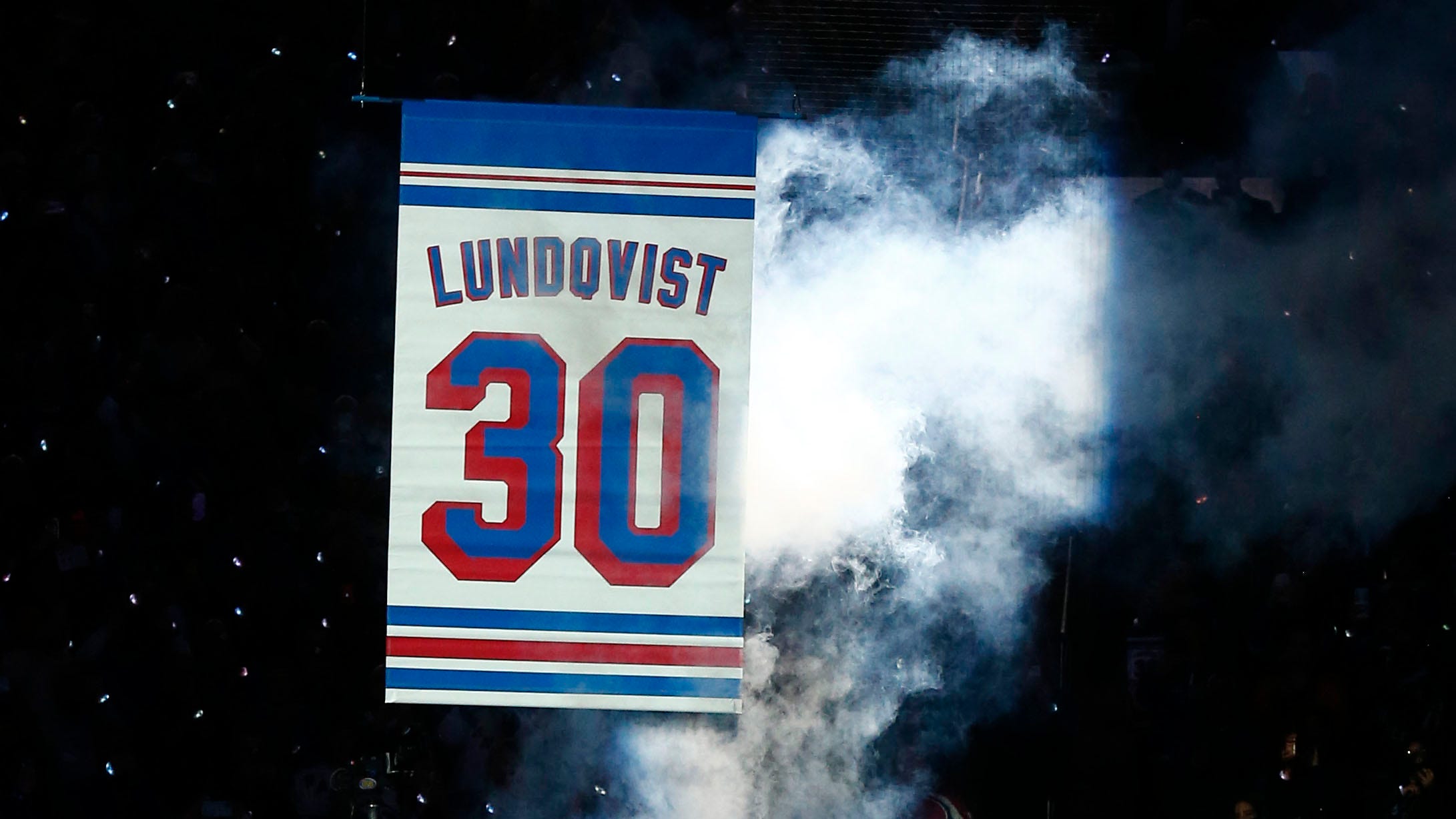 Former New York Rangers goaltender Henrik Lundqvist, center, watches as his  number is retired before an NHL hockey game between the Rangers and the  Minnesota Wild Friday, Jan. 28, 2022 in New