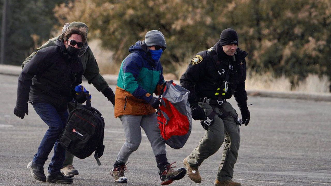 A passenger is rescued Saturday, January 1, 2022, after a Sandia Peak Tramway car that was stranded overnight on New Year's Eve in Albuquerque, N.M. A Bernalillo County Fire Department spokesman said 16 of the stranded people were rescued as of Saturday afternoon as rescue operations continued. The spokesman said those aboard the car when it got stuck at 10 p.m. Friday were all employees of the Sandia Peak Aerial Tramway or a mountaintop restaurant. (Roberto E. Rosales /The Albuquerque Journal via AP)