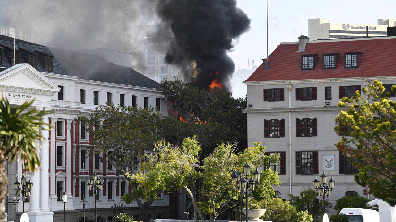 A fire burns at the Houses of Parliament, in Cape Town, South Africa, Sunday, Jan. 2, 2022. The country's minister of public works and infrastructure said Sunday's fire started on the third floor of a building that houses offices and spread to the National Assembly building, where South Africa's Parliament sits. (AP Photo/Leon Knipe)