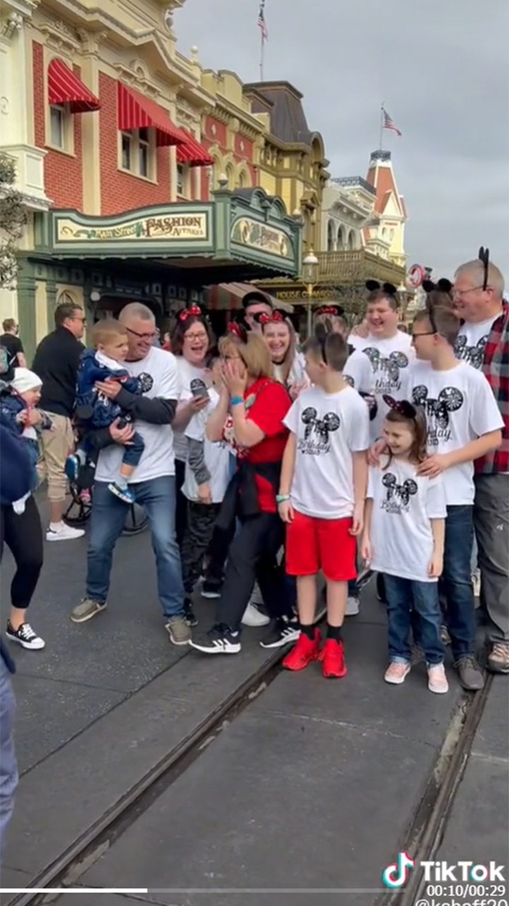 Grandmother surprised at Disney's Magic Kingdom by family for her 70th birthday