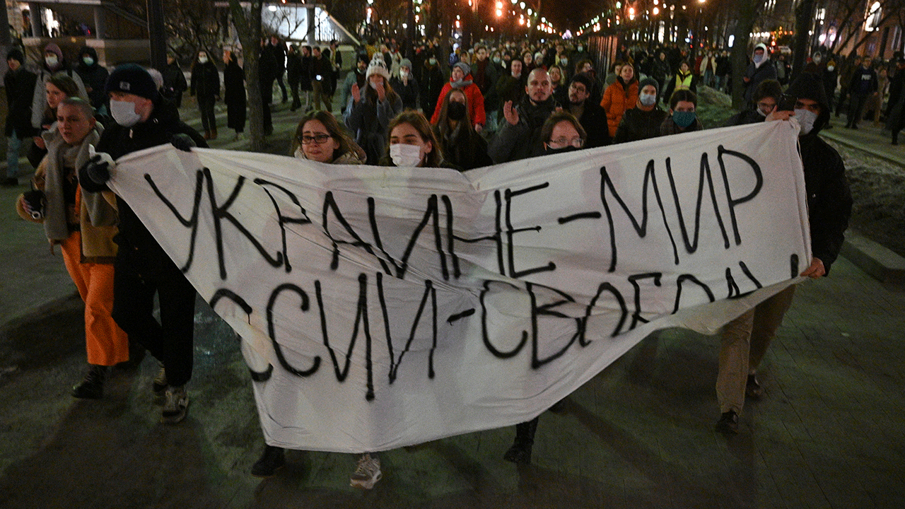 Demonstrators march with a banner that reads "Ukraine – Peace, Russia – Freedom" in Moscow on Feb. 24, 2022, after Russia's attack on Ukraine. (AP)