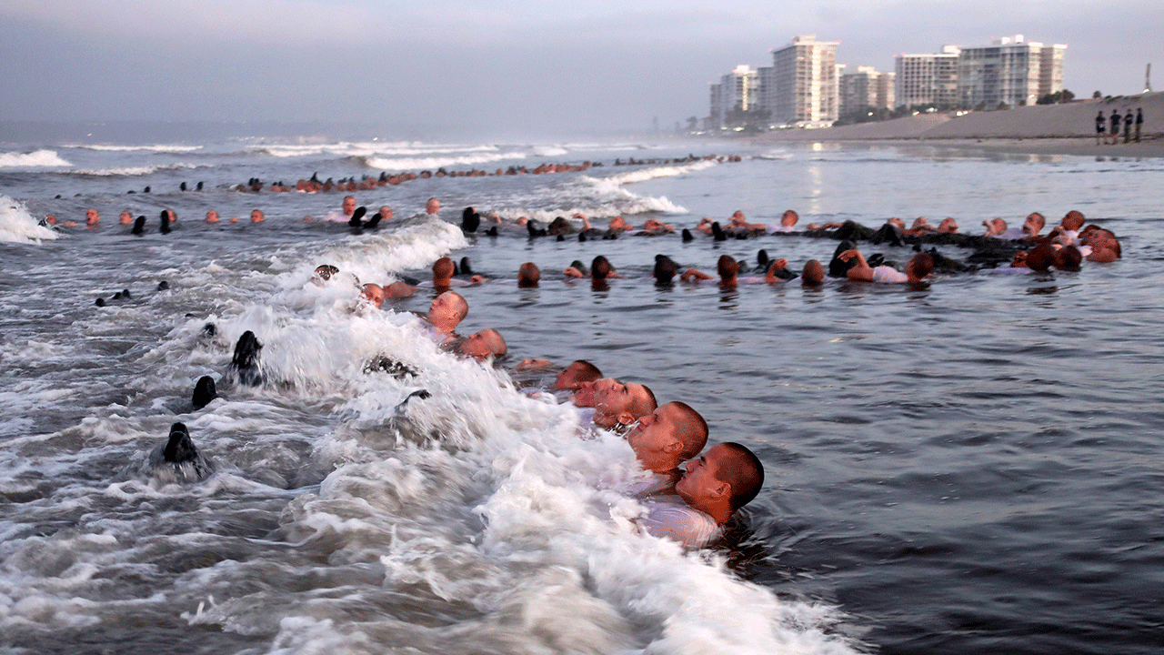 Navy SEAL candidates, participate in "surf immersion" during Basic Underwater Demolition/SEAL training at the Naval Special Warfare Center in Coronado, California.