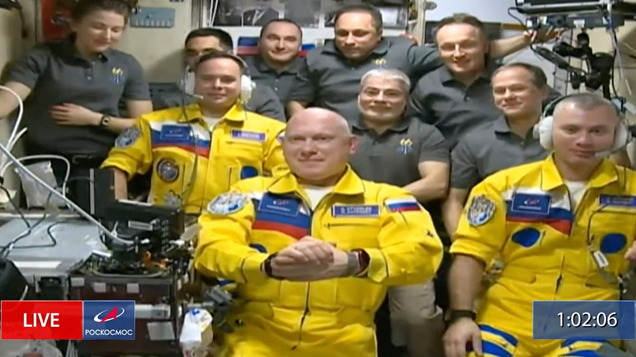 Russian cosmonauts wear Ukrainian colors in arrival at International Space Station