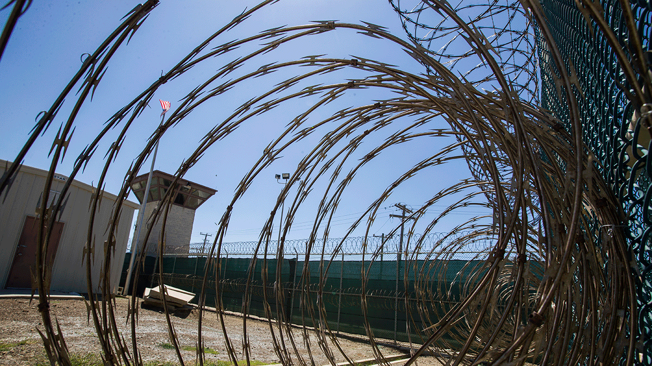 In this April 17, 2019, photo, reviewed by U.S. military officials, the control tower is seen through the razor wire inside the Camp VI detention facility in Guantanamo Bay Naval Base, Cuba.