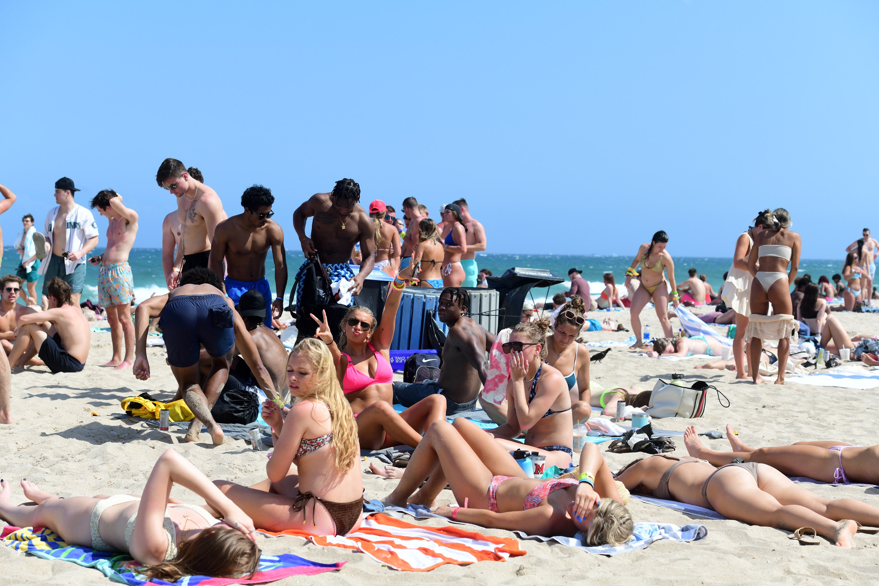 Fort Lauderdale spring breakers having fun in the sun as Miami Beach guests simmer over curfew