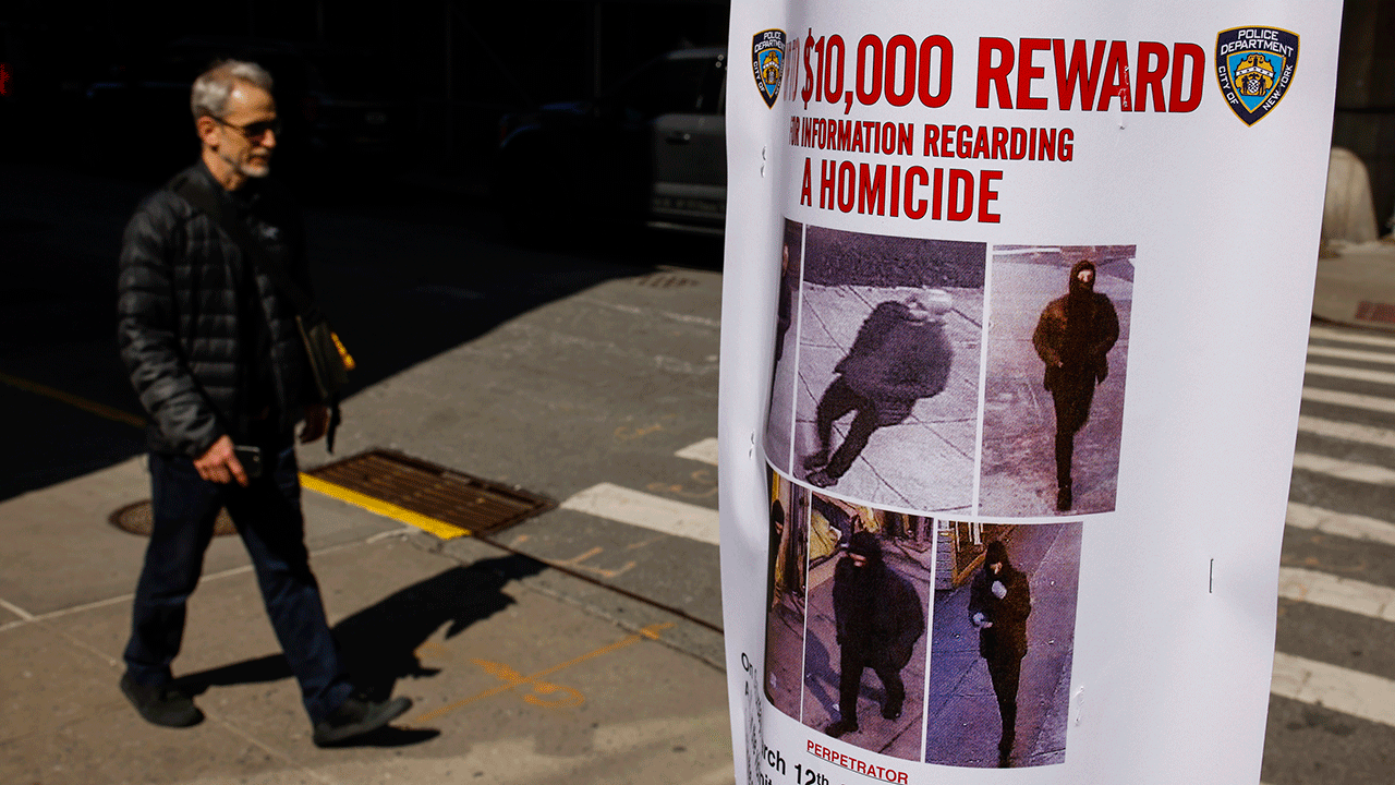 A pedestrian walks past a bulletin posted by NYPD near the place where a homeless person was killed days earlier in lower Manhattan, Monday, March 14, 2022, in New York. 