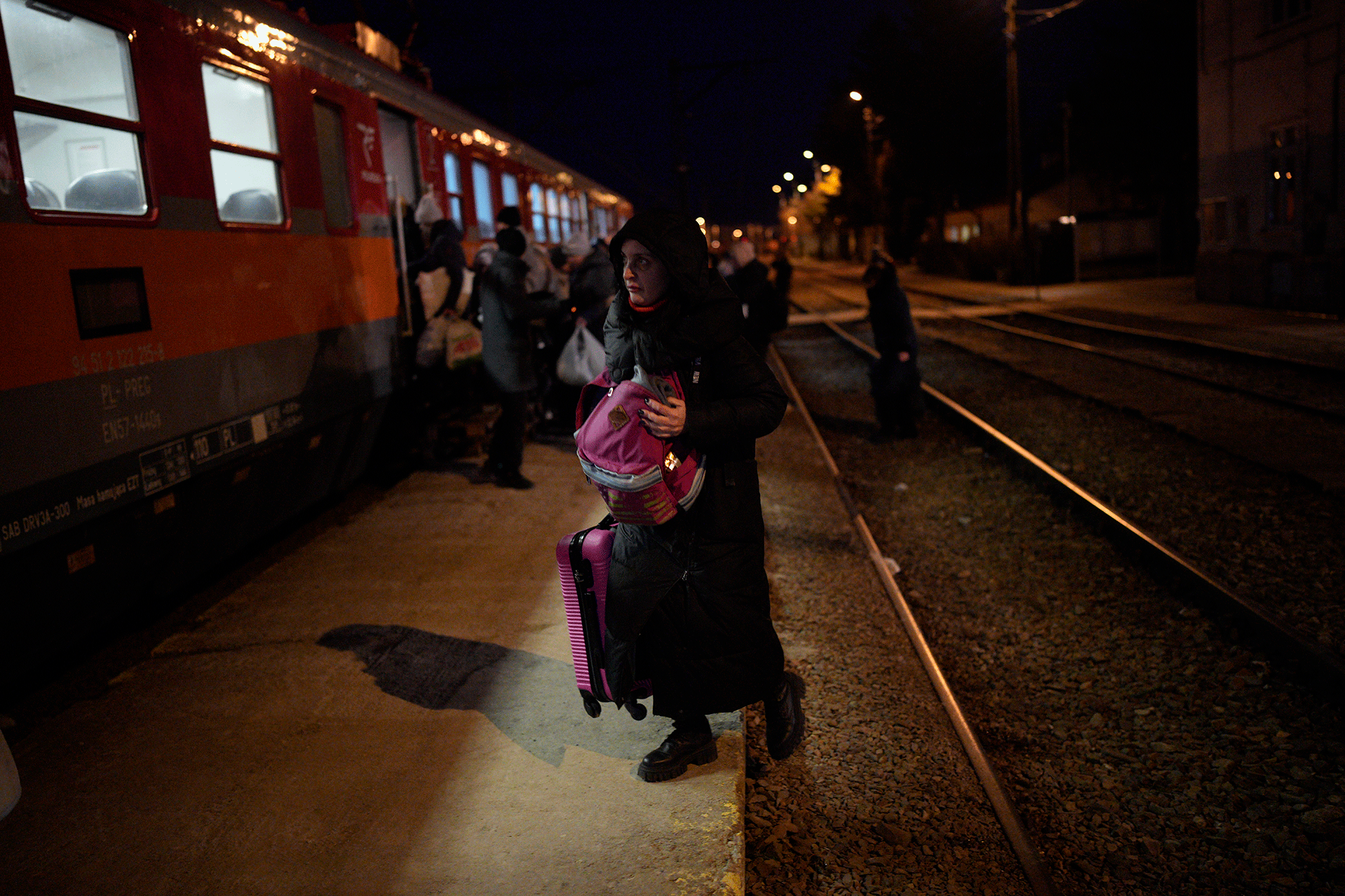 Refugees fleeing war in neighboring Ukraine board a train at the Medyka border crossing, Poland, Thursday, March 10, 2022. (AP Photo/Daniel Cole)