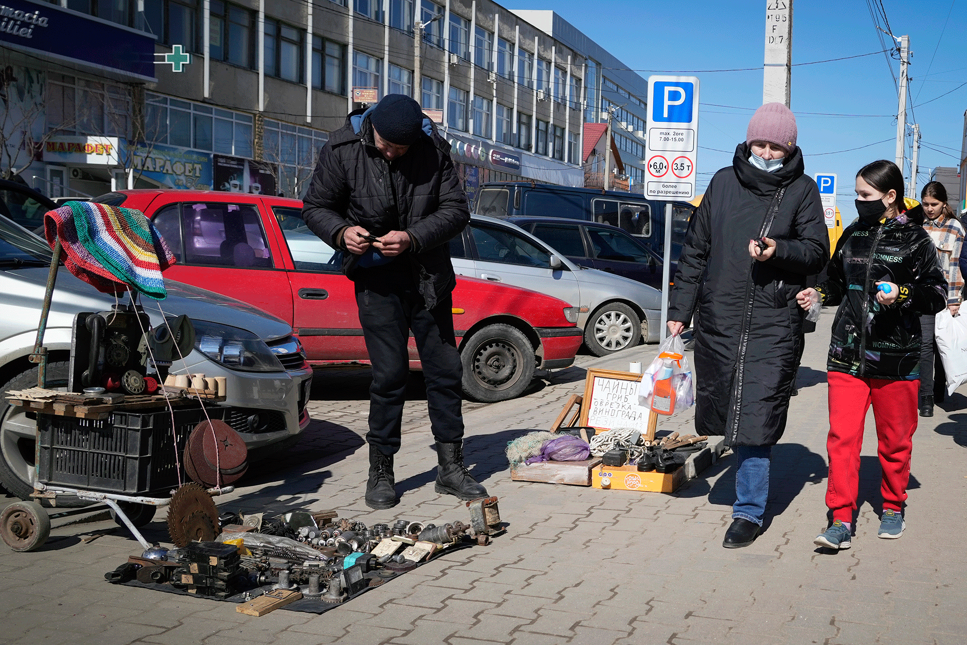 A vendor trades at a street market in Comrat, Moldova, Saturday, March 12, 2022. Across the border from war-engulfed Ukraine, tiny, impoverished Moldova, an ex-Soviet republic now looking eagerly Westward, has watched with trepidation as the Russian invasion unfolds. 