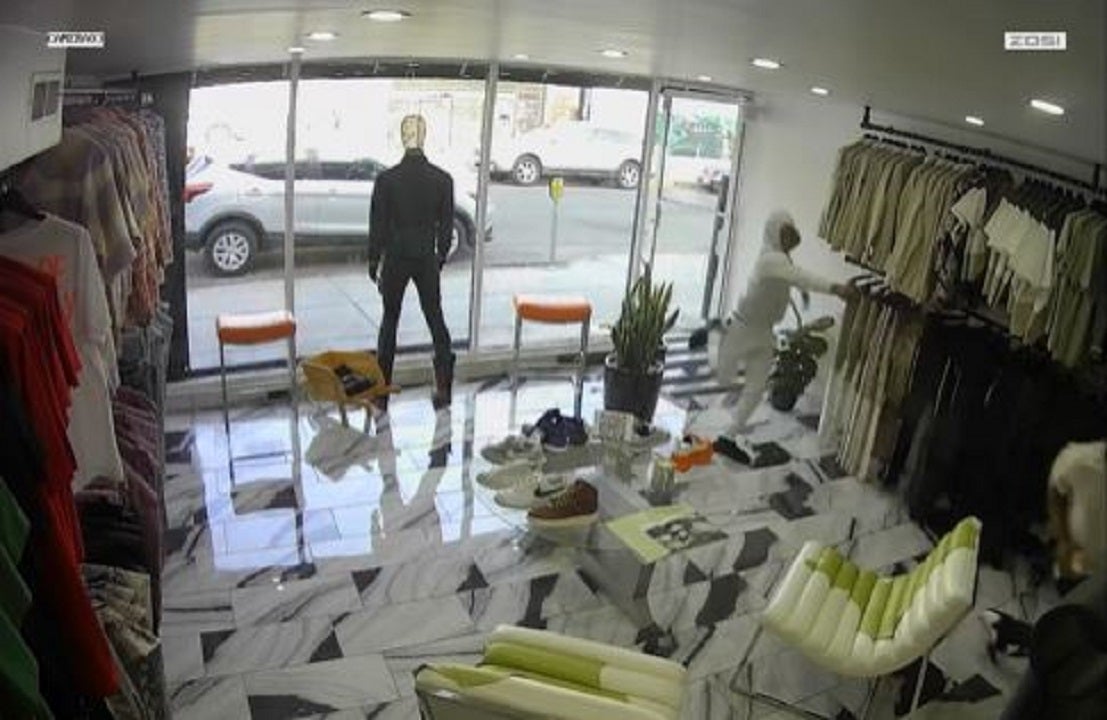 LA attempted robbery spills into clothing store as security footage shows suspect brandish gun