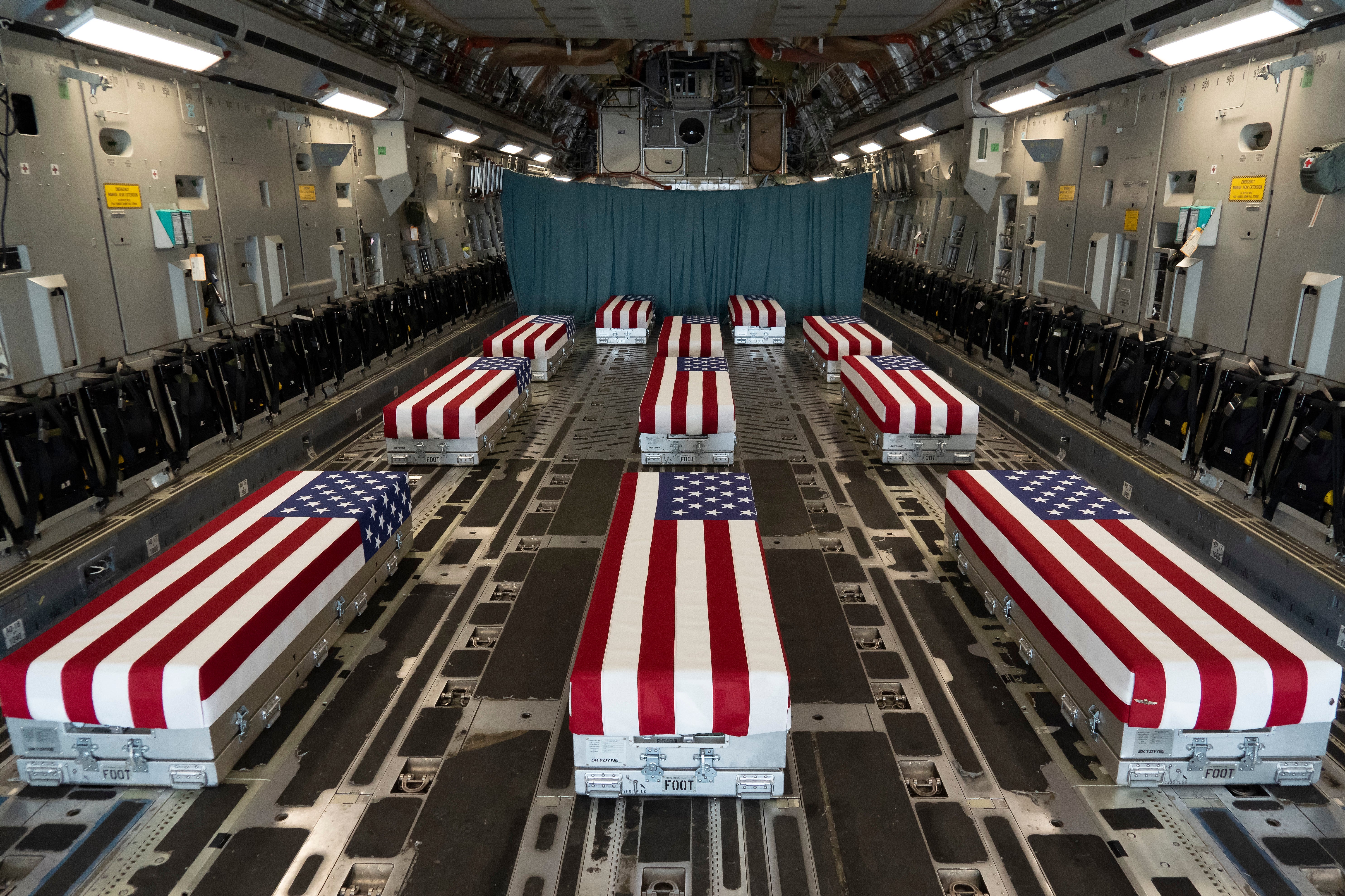 flag-draped caskets in cargo jet