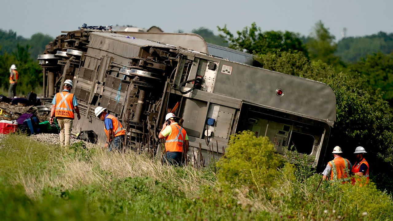 Workers inspect the scene of an Amtrak train which derailed after striking a dump truck Monday, June 27, 2022, near Mendon, Mo. (AP Photo/Charlie Riedel) (AP Photo/Charlie Riedel)