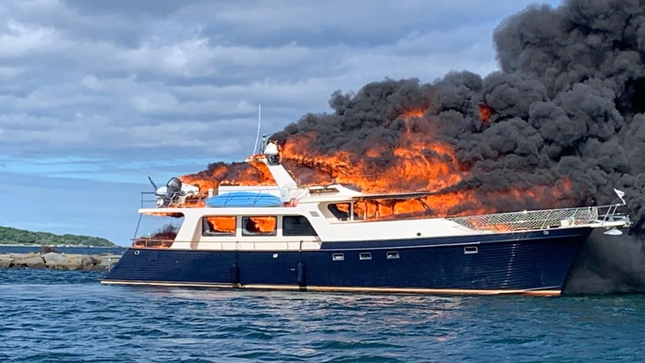 New Hampshire yacht fire on river forces three people and two dogs to jump overboard