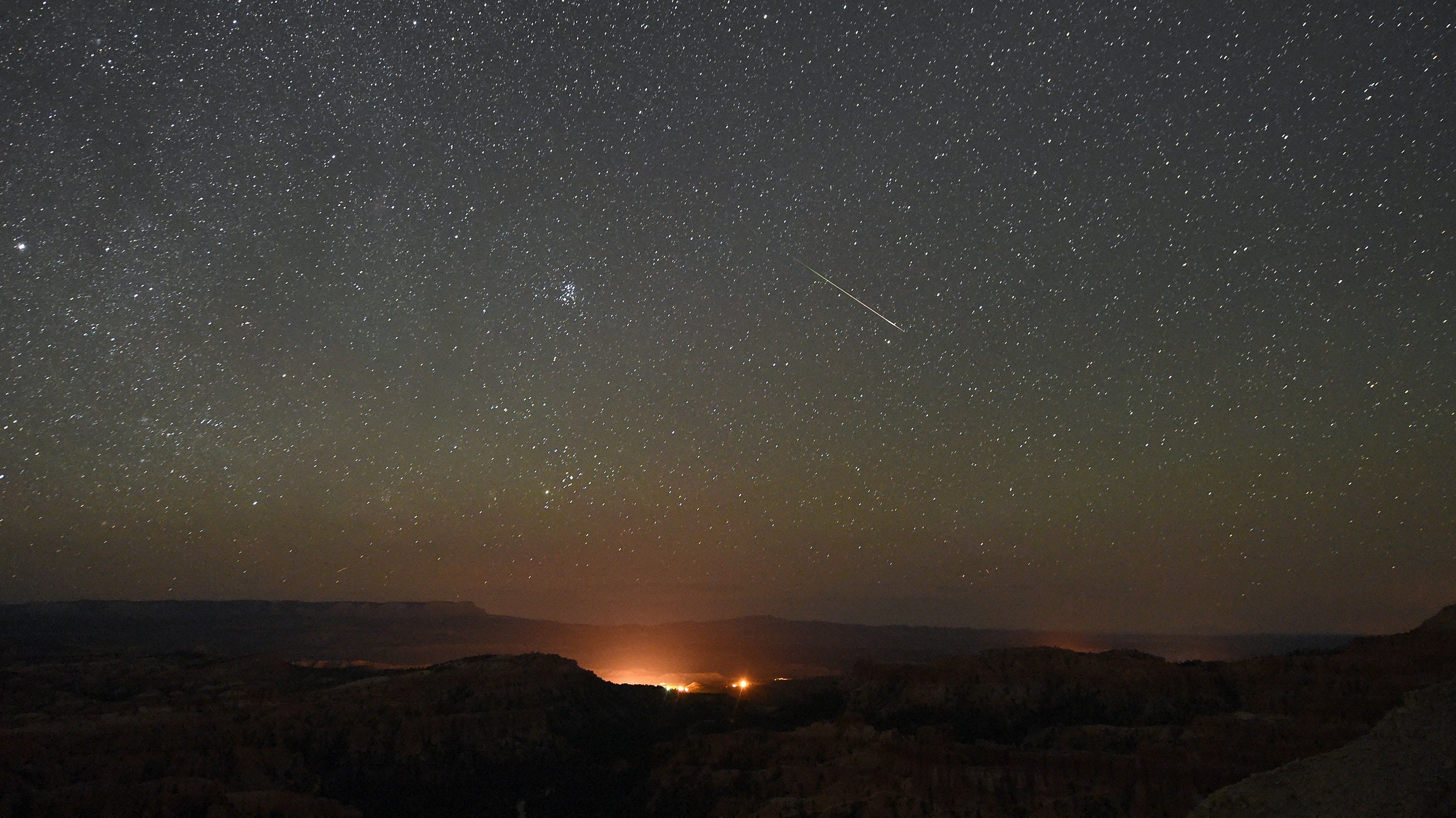 A Perseid meteor streaks across the sky above Inspiration Point early on August 12, 2016 in Bryce Canyon National Park, Utah. ( (Photo by Ethan Miller/Getty Images))
