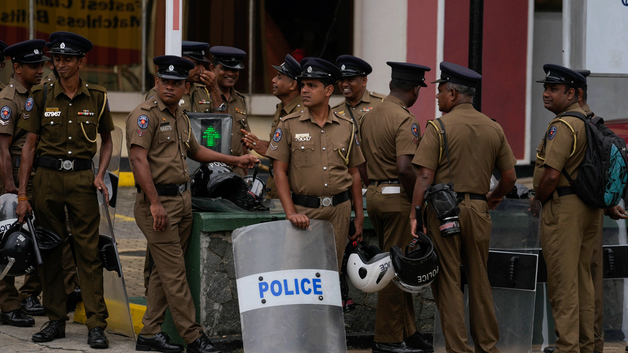 Police officers in Sri Lanka standing outside with riot shields