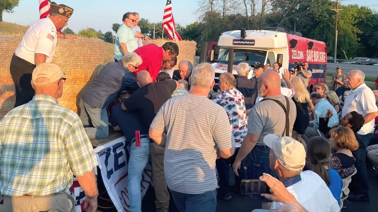 Congressman Lee Zeldin stands on stage during his stump speech, before an alleged attack on him, in Fairport, New York, United States, July 21, 2022.  (Ian Winner/Handout via REUTERS)