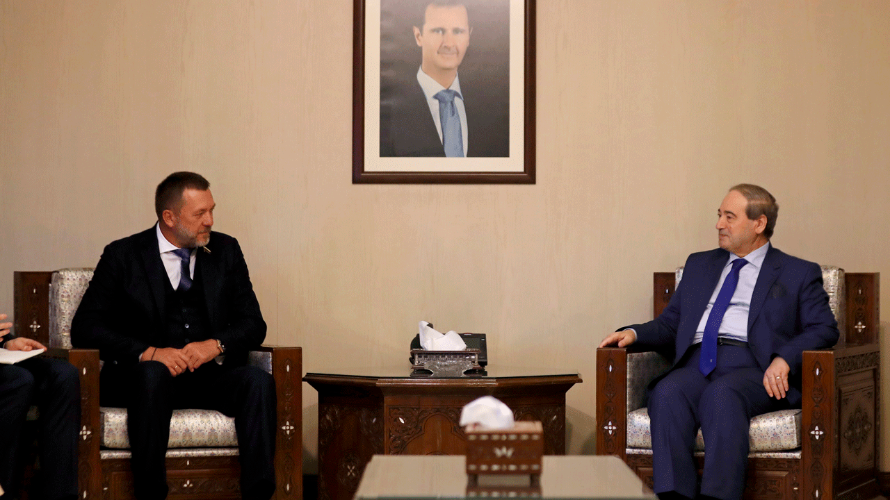 FILE - Syrian Foreign Minister Faisal Mekdad, right, meets with Russian lawmaker Dmitry Sablin, who visits Syria as part of a large Russian delegation that includes the foreign minister for the breakaway pro-Russian area in Ukraine, the so-called "Donetsk People's Republic", in Damascus, Syria, Tuesday, June 14, 2022. Syria said Wednesday, July 20, 2022, that it is formally breaking diplomatic ties with Ukraine in response to a similar move by Kyiv. Syria is a strong ally of Russia, which joined Syria’s conflict in September 2015 in favor of President Bashar Assad. (AP Photo/Omar Sanadiki, File) 