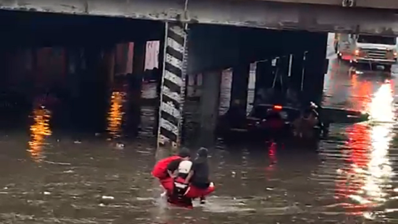 Denver firefighters seen on video rescuing children from floodwaters