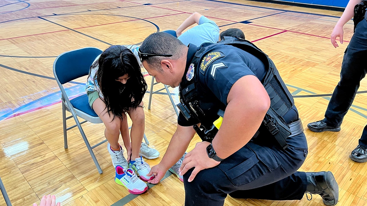 Dallas police officers distribute new shoes to kids who need them