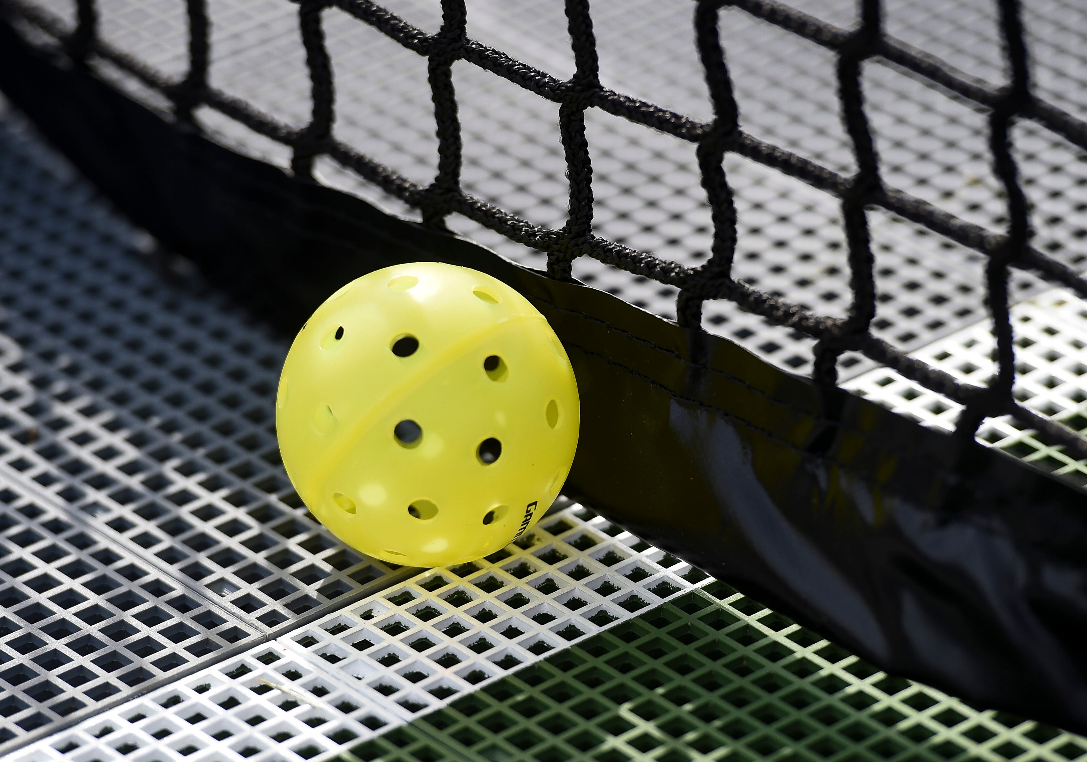 A plastic pickleball