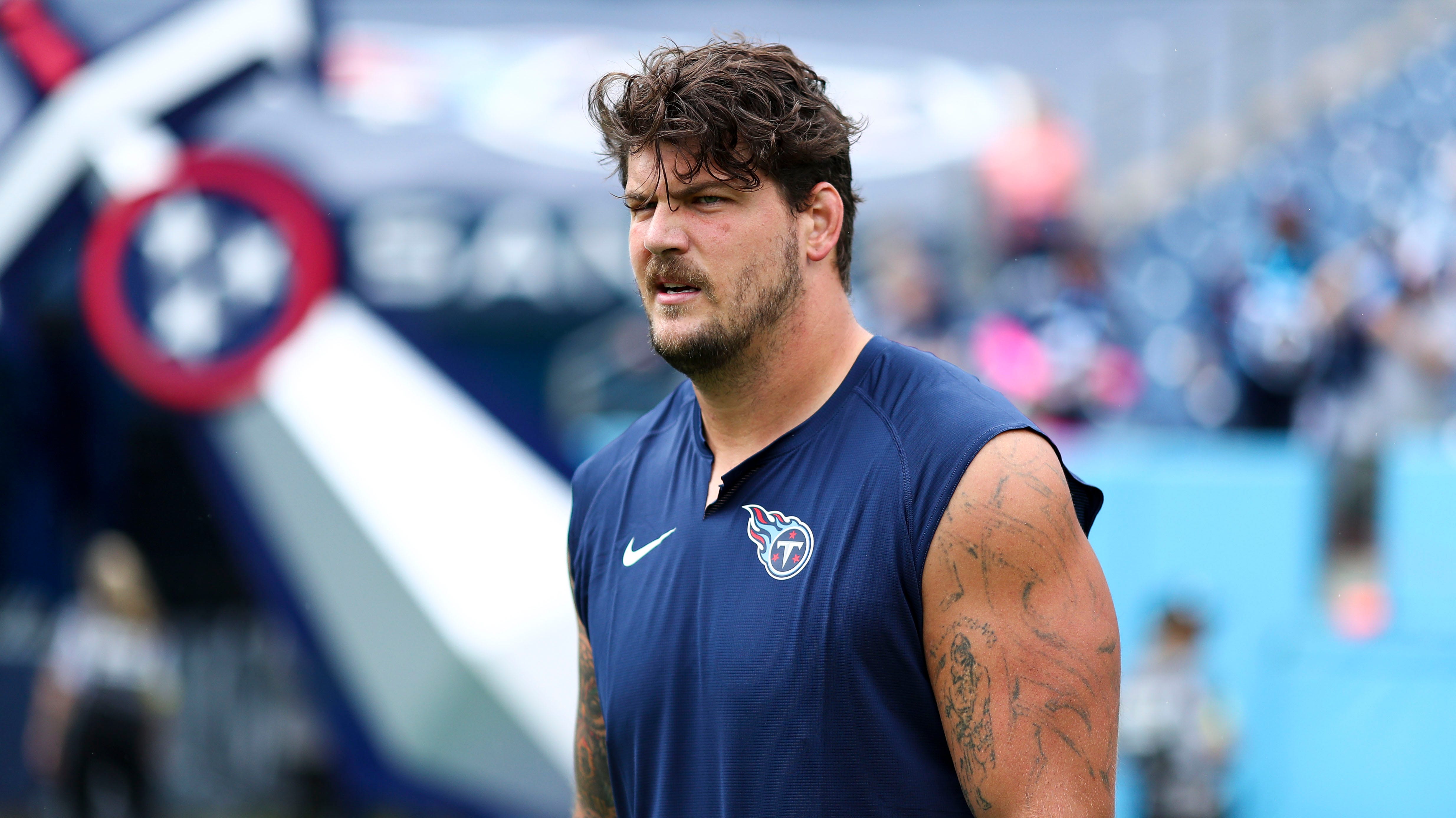 Titans' Taylor Lewan carted off with knee injury vs. Bills