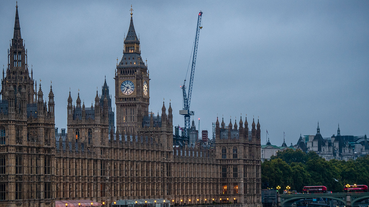 Photo shows the The Houses of Parliament in front of dark sky
