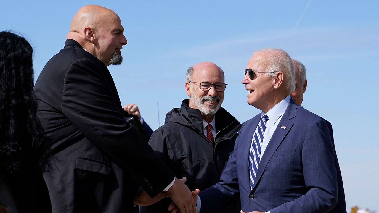 President Joe Biden speaks with Pennsylvania Lt. Gov. John Fetterman, a Democratic candidate for U.S. Senate, after stepping off Air Force One, Thursday, Oct. 20, 2022, at the 171st Air Refueling Wing at Pittsburgh International Airport in Coraopolis, Pa. Biden is visiting Pittsburgh to promote his infrastructure agenda. (AP Photo/Patrick Semansky)