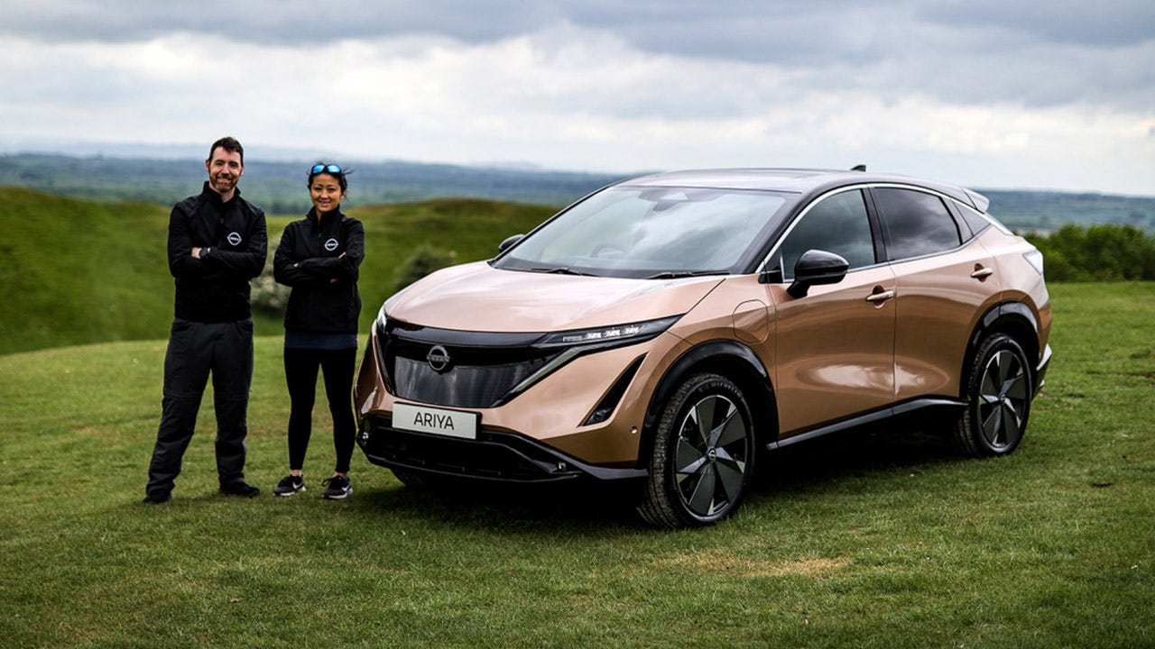 Married couple driving electric car from North to South Pole