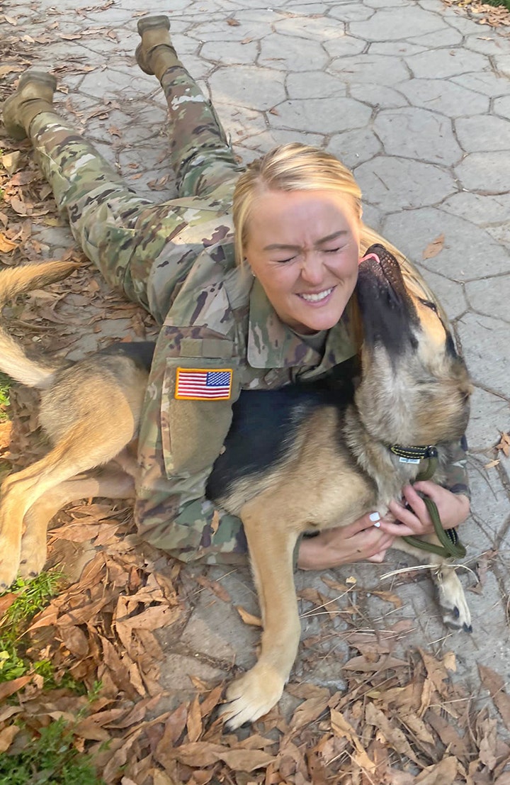 Staff Sgt. Andrea Taulton, who was deployed to Kosovo, gets kisses from the rescue pup, Axel, that she's trying to bring home to America. (Paws of War)