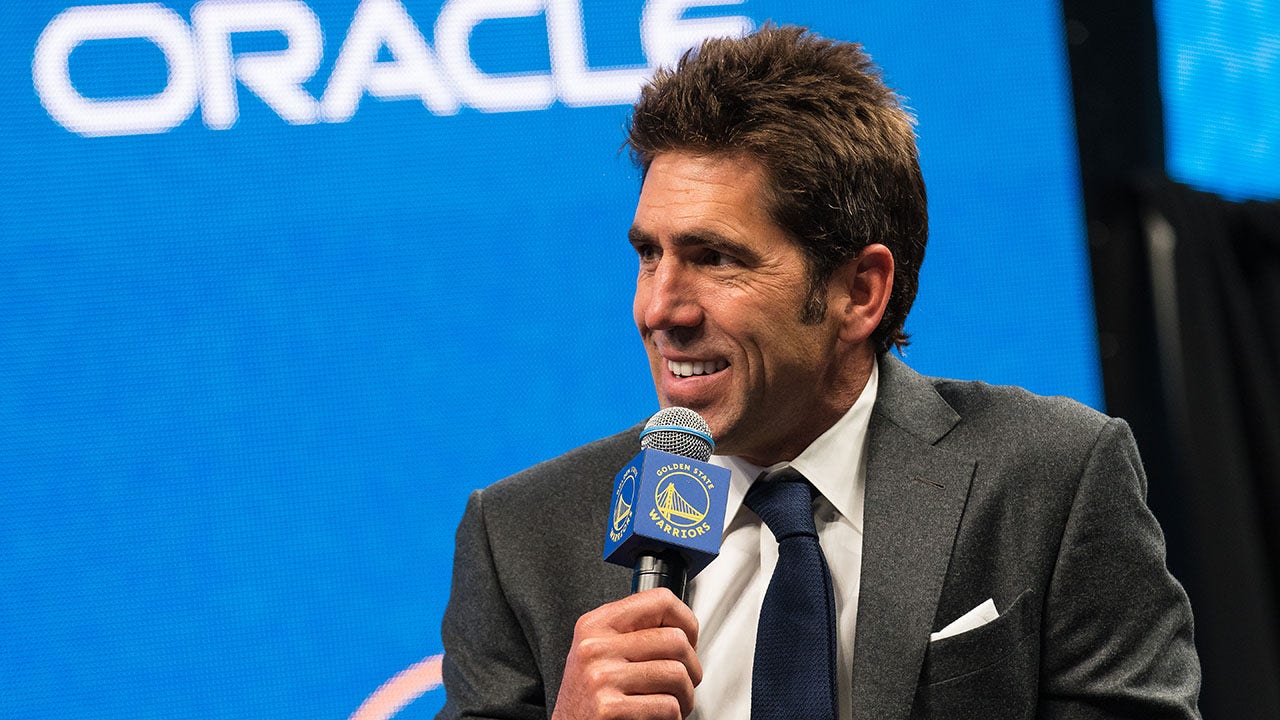 Golden State Warriors general manager Bob Myers, right, watches