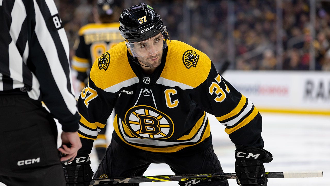 Patrice Bergeron gets ready for a faceoff against the Canucks